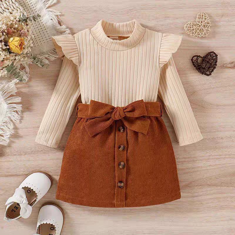 طقم شتوي (بلوزة مضلعة وتنورة كوردروي) بفيونكة كبيرة