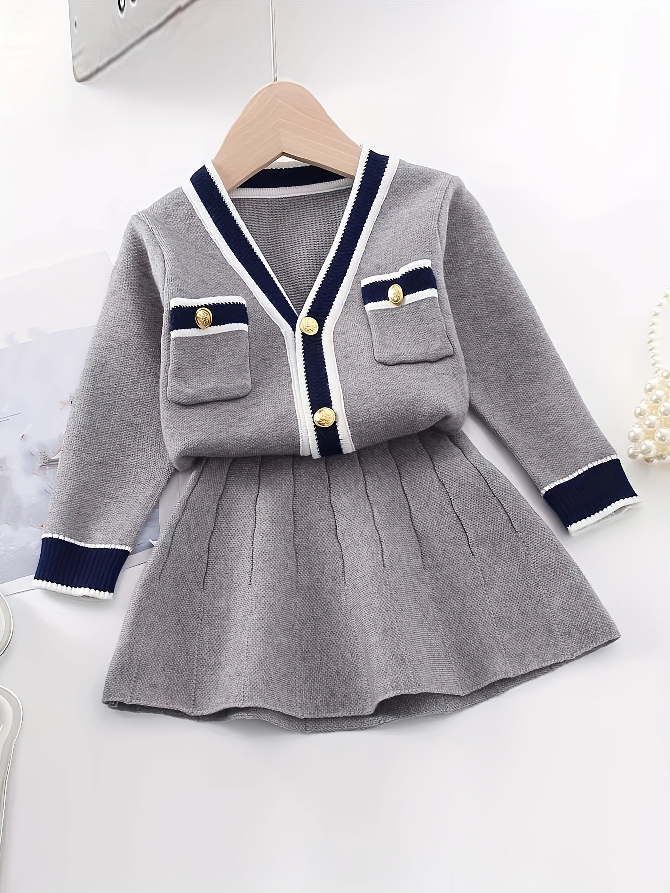 طقم شتوي منسوج بلون رمادي فاتح وتفاصيل ذهبية فاخرة