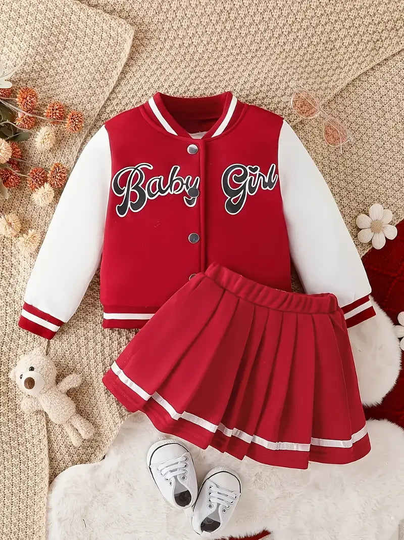 طقم قطعتين جاكيت وعبارة "Baby Girl" وتنورة مطوية