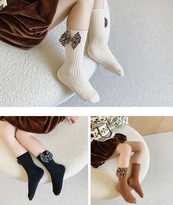 مجموعة جوارب مزينة بفيونكات قماشية للبنات